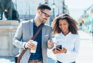 two people on the street smiling to show mobile friendliness and to increase website search engine optimized